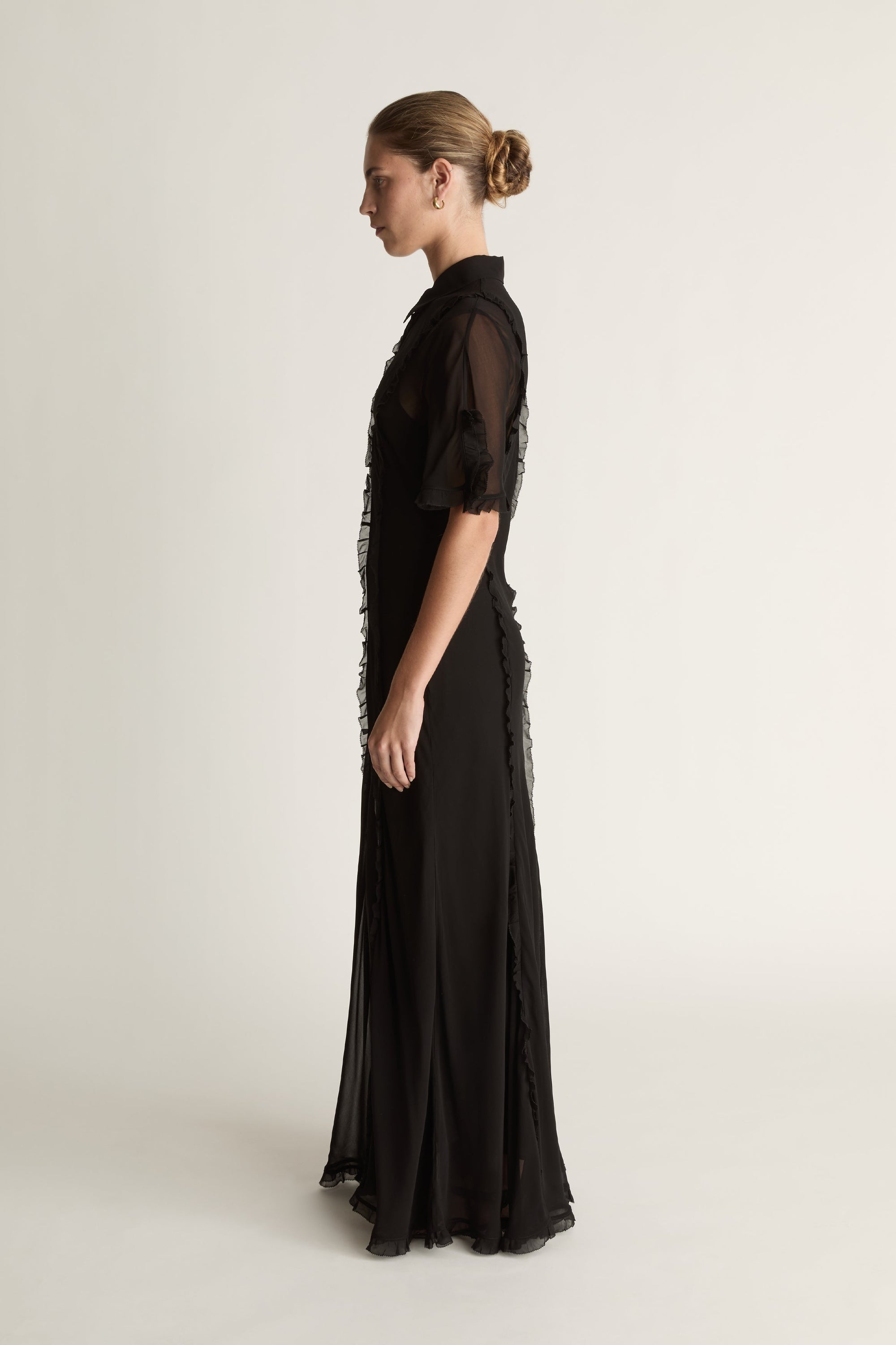 Black dress with sheer sleeves on a white background