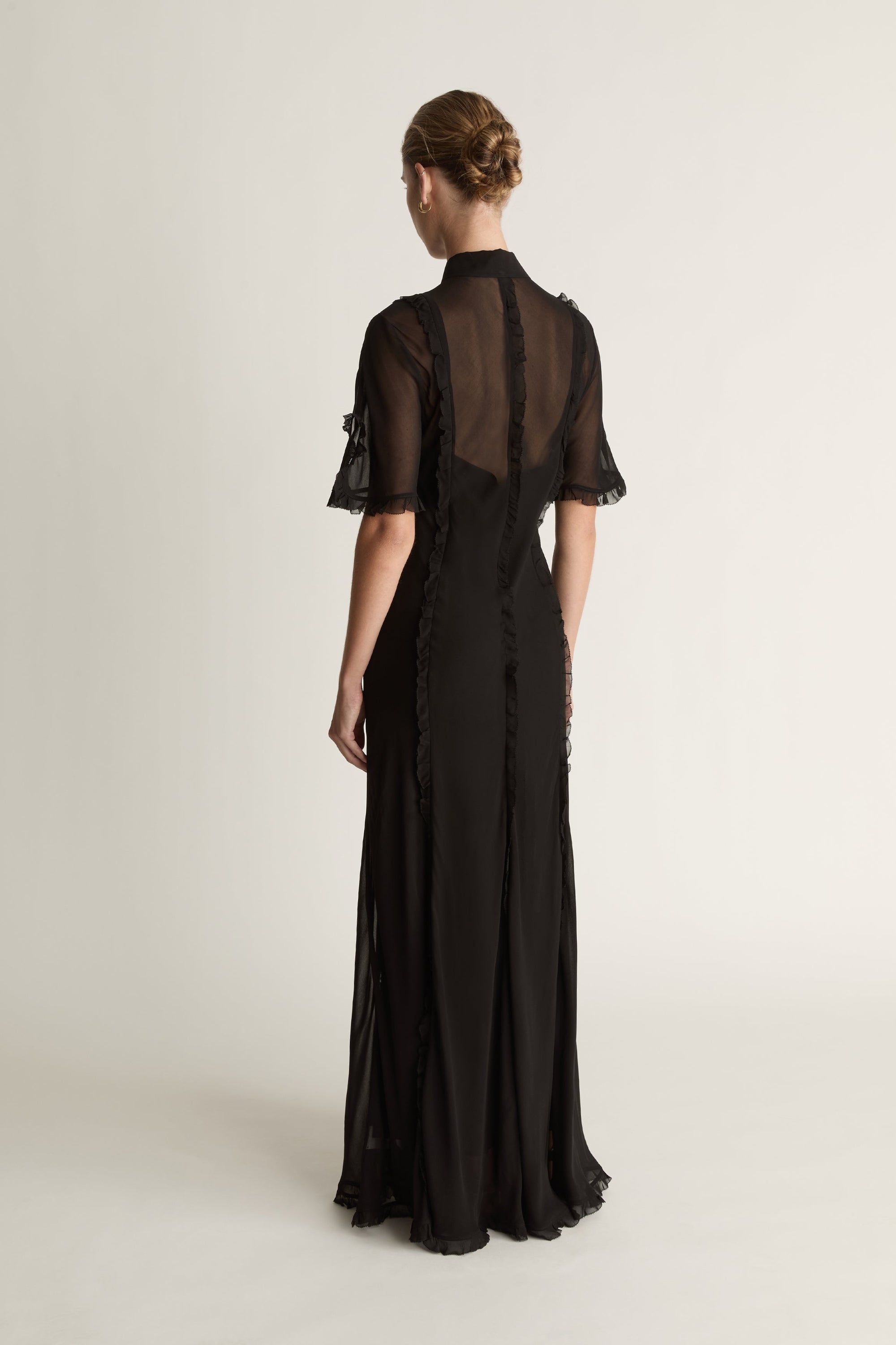 Black dress with sheer sleeves on a white background