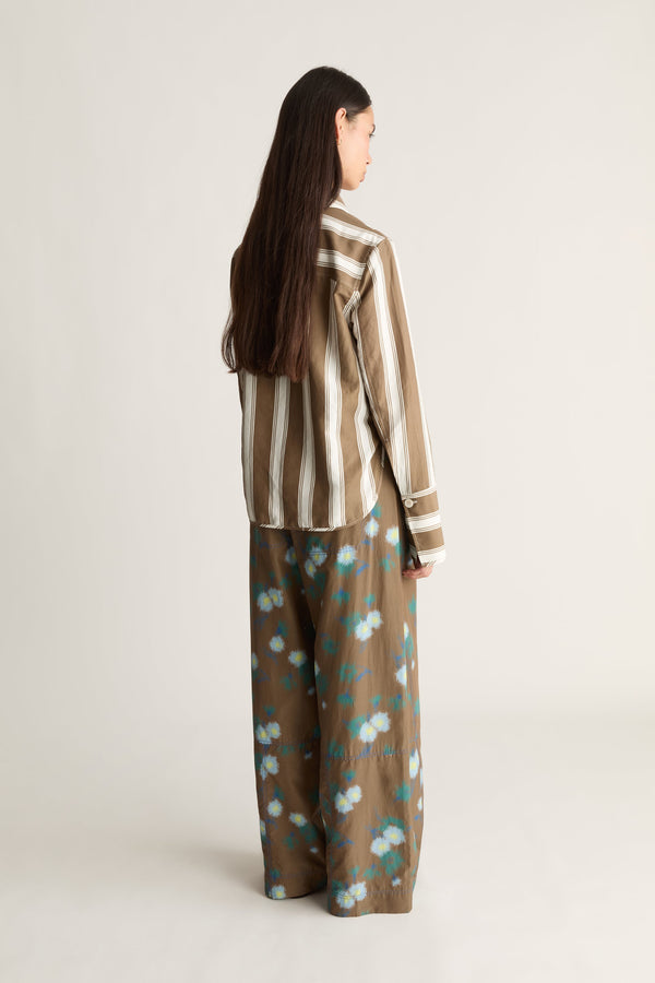 Woman wearing brown striped button-up shirt and floral wide-leg pants — mixed-print co-ord outfit