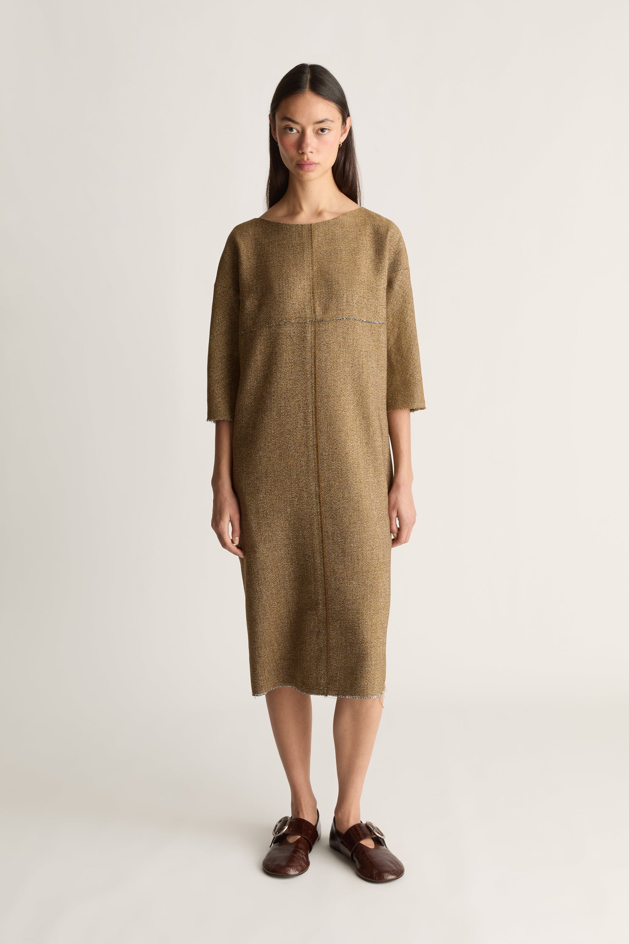 Front view image of a woman wearing a brown midi length dress with 3/4 sleeves on a white background