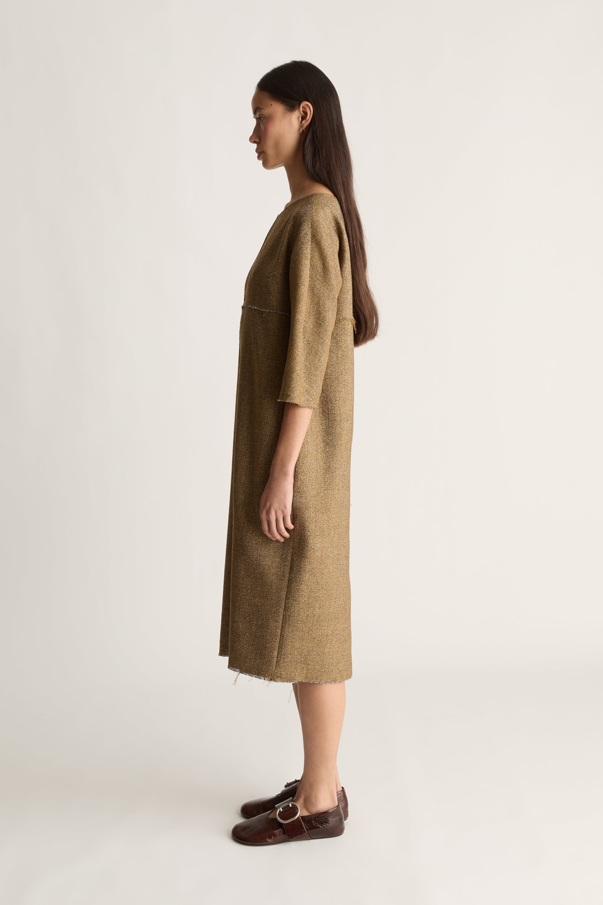 A side view image of a woman wearing the Esme Dress in Nutmeg on a white background