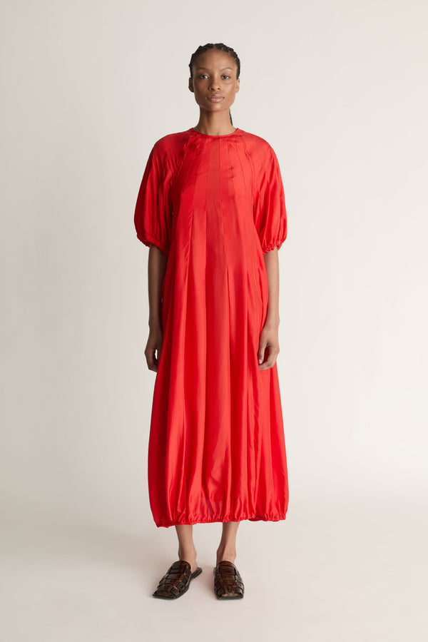 Person wearing a red dress on a white background