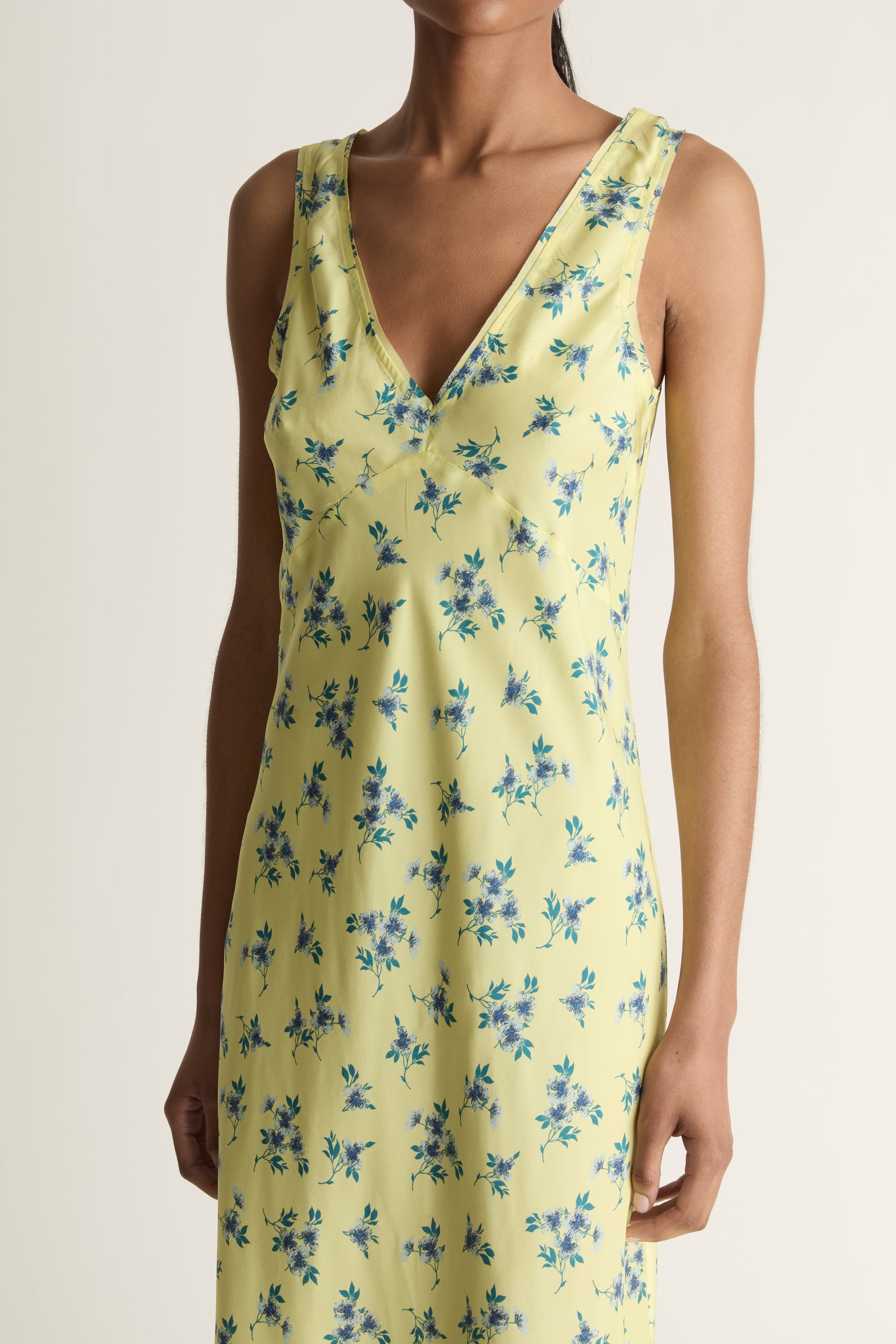 Close-up image of a woman wearing the Maisie Silk Slip dress on a white background background