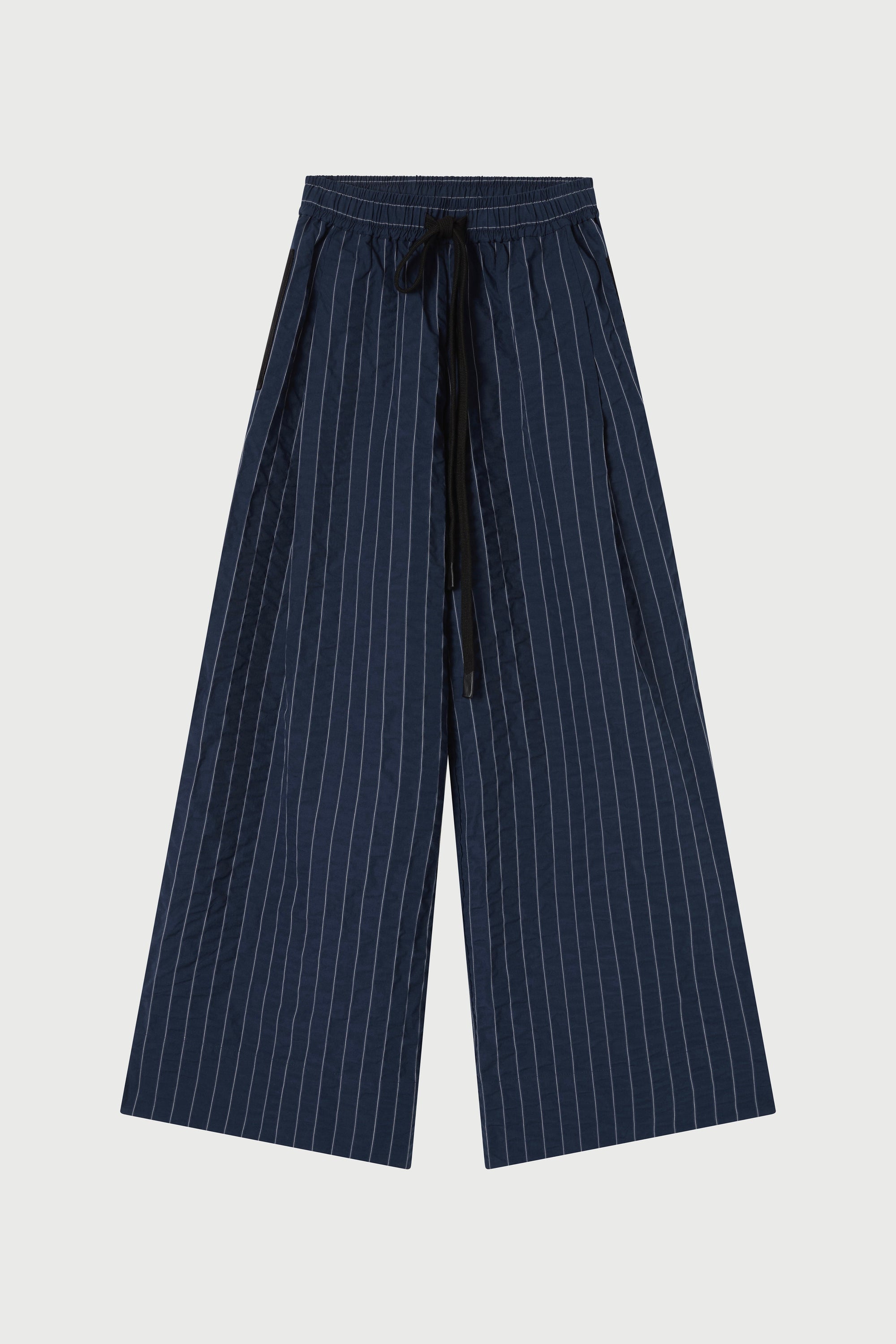 Navy pinstripe pants on a light gray background