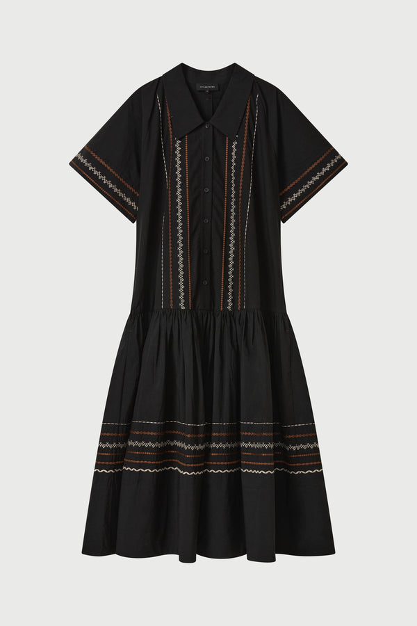 Black dress with intricate patterns on a white background