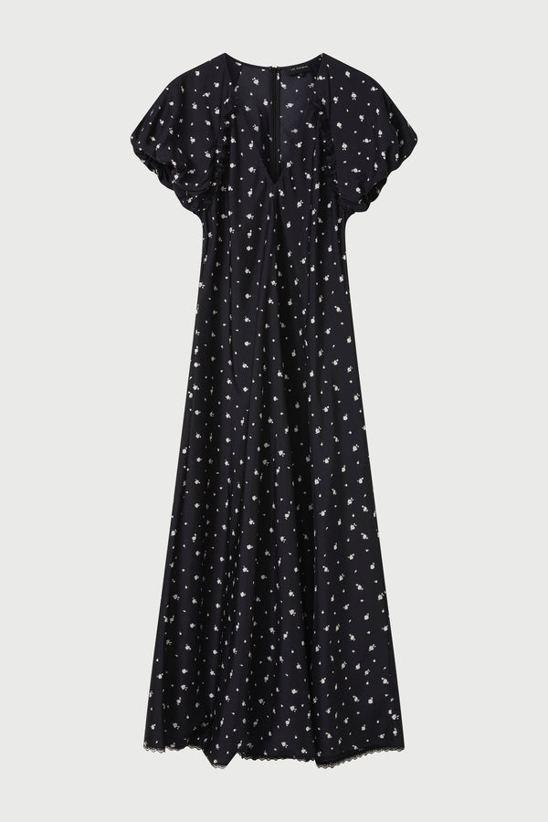 Black dress with white pattern on a light gray background